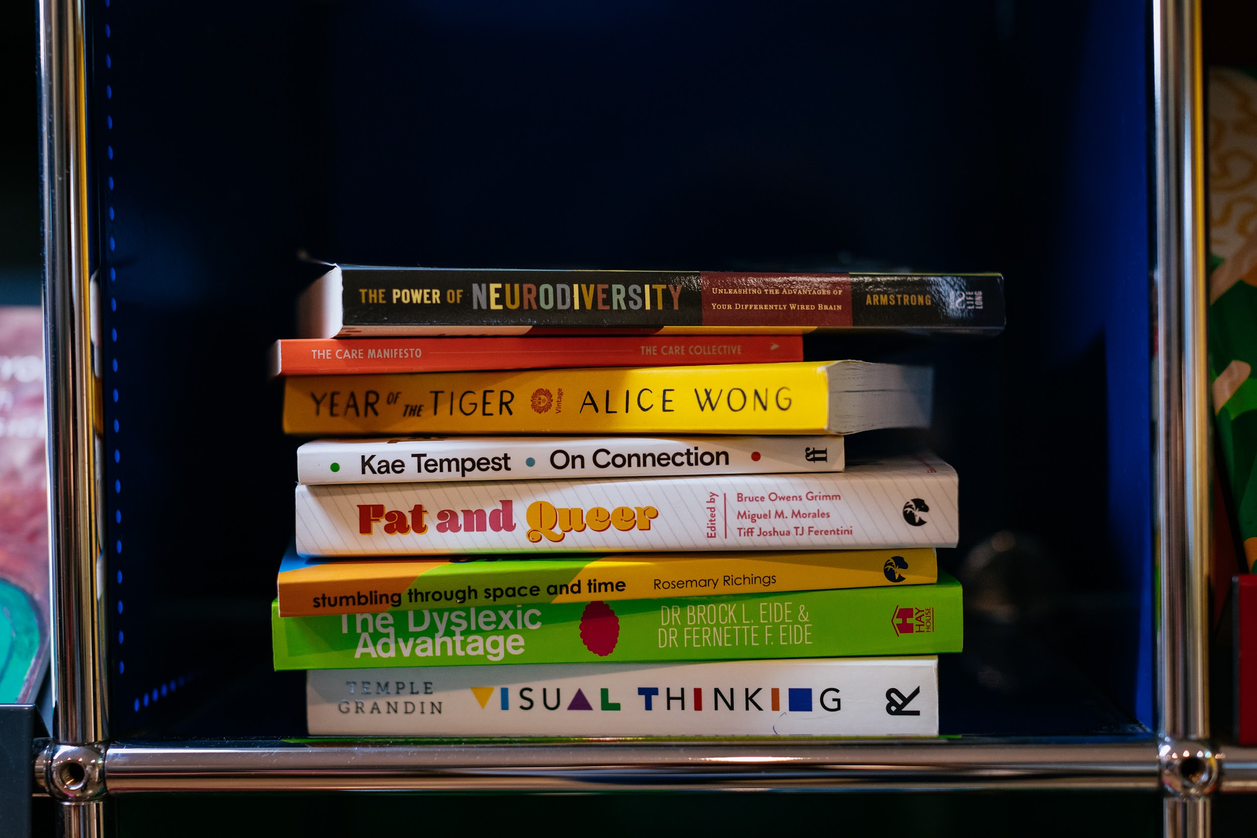 A stack of literature in Project Art Centre’s lobby. Titles include; The power of neurodiversity, The care manifesto, year of the tiger, on connection, fat and queer, The dyslexic advantage, visual thinking and stumbling through space and time. Photo by Simon Lazewski.